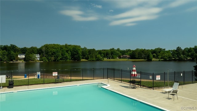 view of swimming pool with a water view