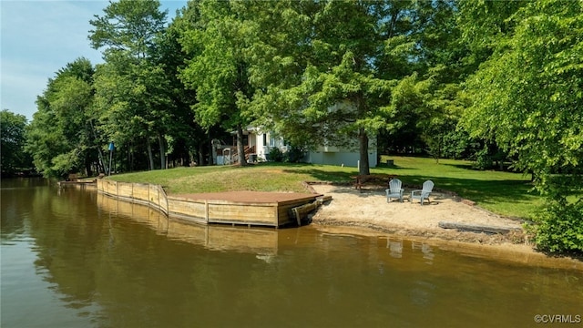 view of property's community featuring a yard and a water view