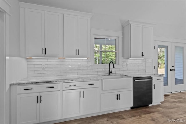 kitchen featuring a sink, white cabinetry, backsplash, and dishwasher