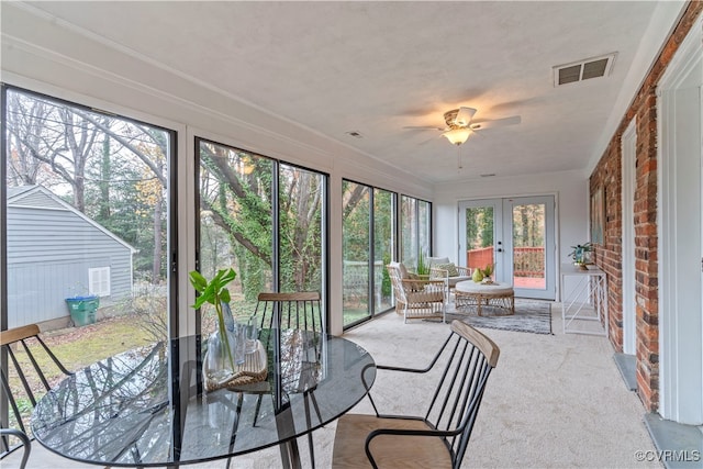 sunroom / solarium featuring ceiling fan