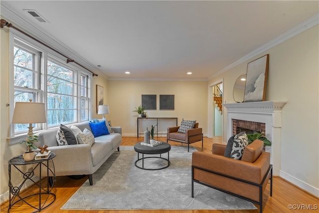 living room with light wood-type flooring and ornamental molding