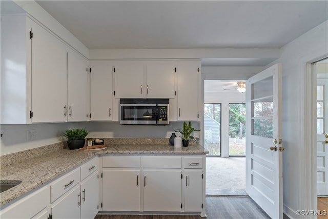 kitchen with white cabinets and light wood-type flooring