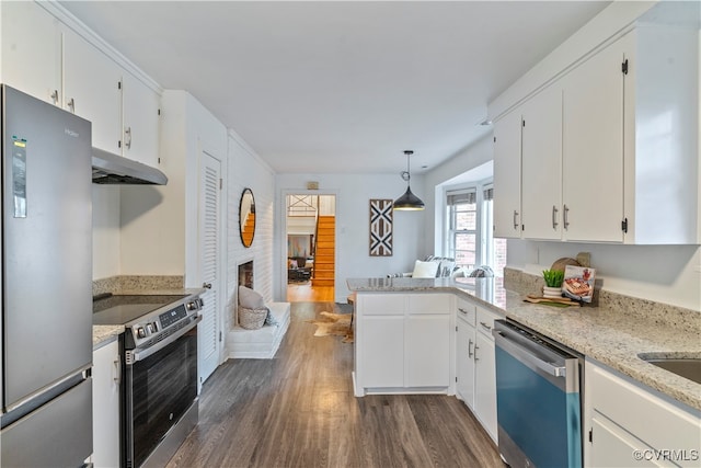 kitchen featuring white cabinetry, pendant lighting, dark hardwood / wood-style floors, and appliances with stainless steel finishes