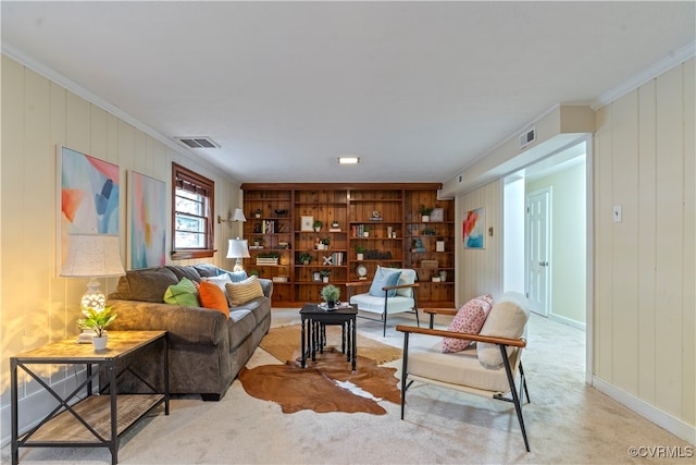 carpeted living room featuring crown molding and wooden walls