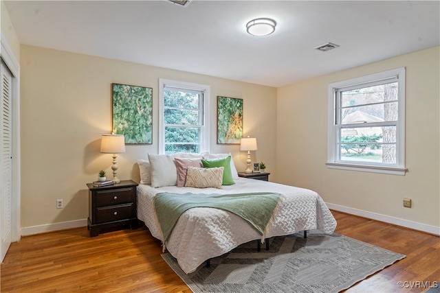 bedroom with a closet and hardwood / wood-style floors