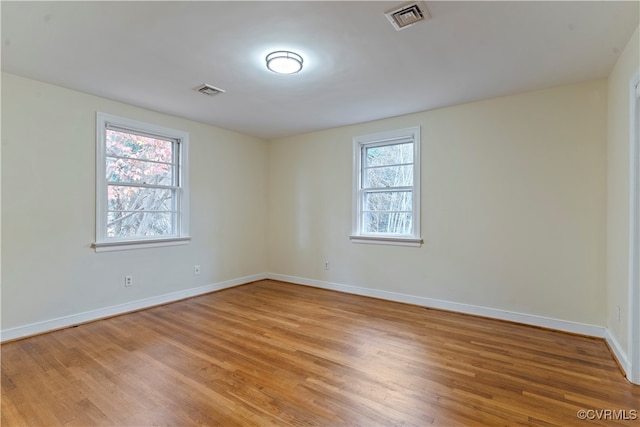 unfurnished room with light hardwood / wood-style floors