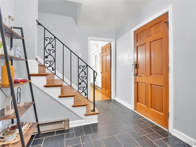 foyer entrance featuring a baseboard radiator