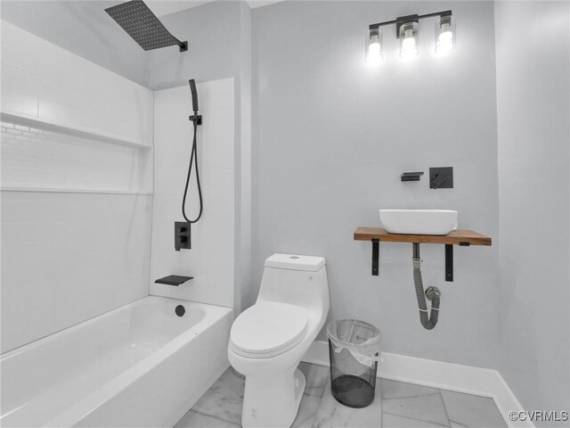 bathroom featuring toilet and tiled shower / bath