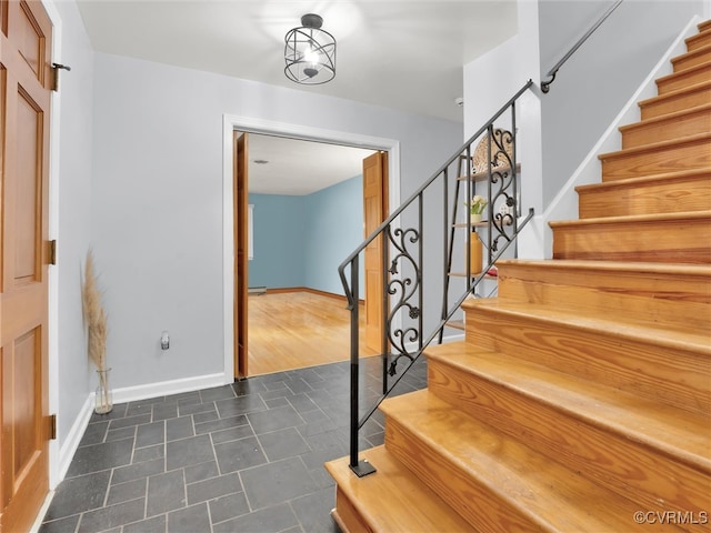 staircase with hardwood / wood-style flooring