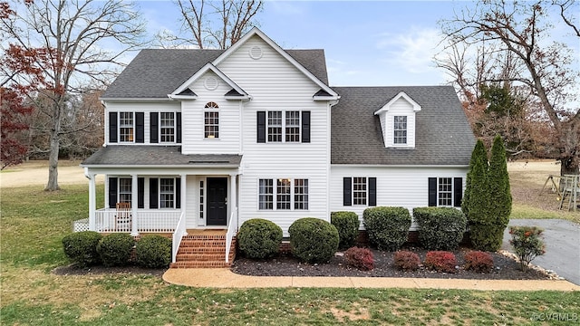 view of front of home with covered porch and a front yard