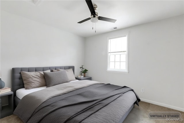 bedroom featuring light colored carpet and ceiling fan