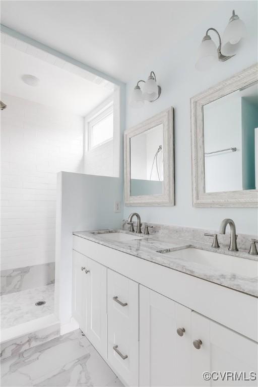 bathroom featuring walk in shower and vanity