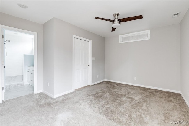 spare room featuring light colored carpet and ceiling fan