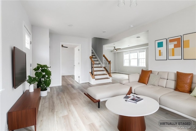 living room with ceiling fan and light hardwood / wood-style floors