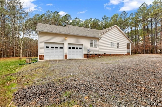 view of side of home with a garage