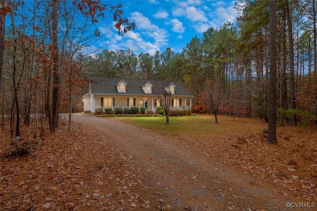 cape cod home featuring a porch