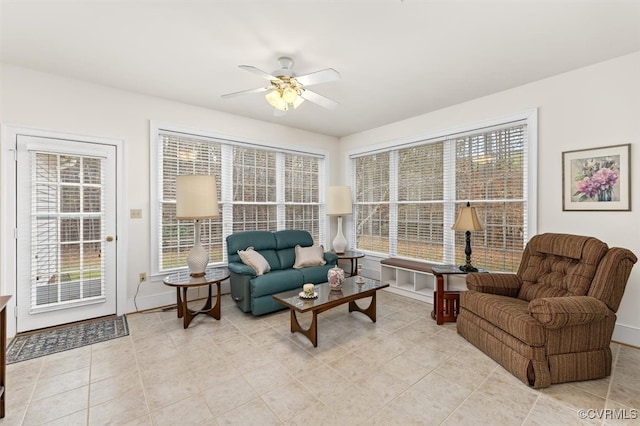 living room featuring ceiling fan and light tile patterned floors