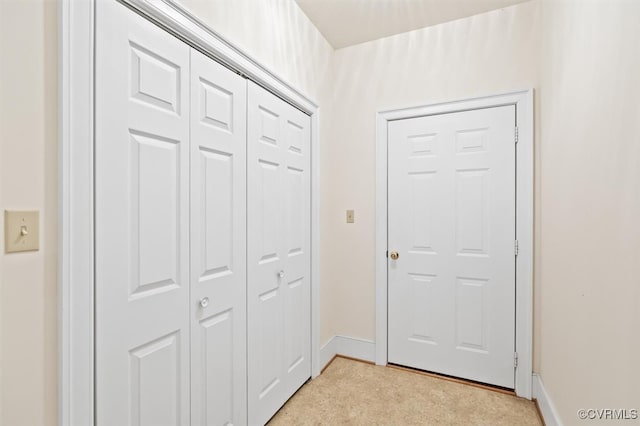 corridor with light colored carpet