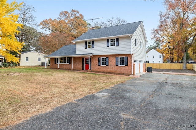 view of front of home with a front yard and a garage