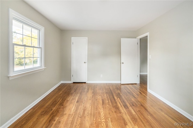 unfurnished room featuring hardwood / wood-style floors