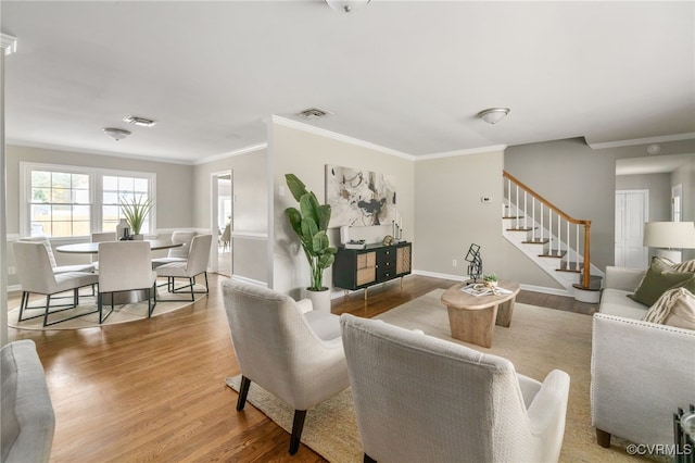 living room with crown molding and wood-type flooring