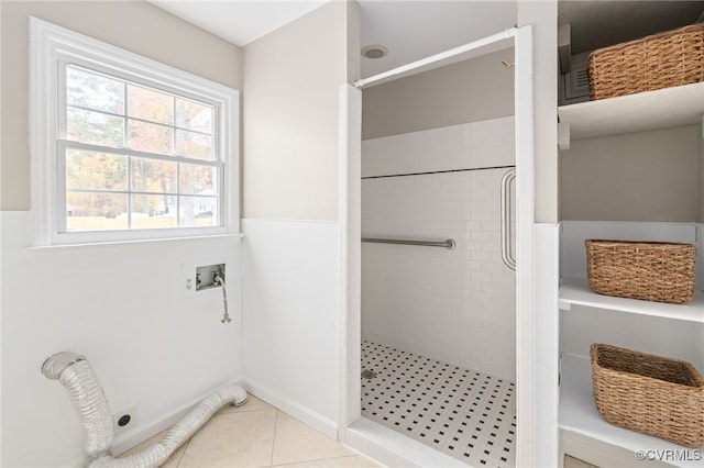 bathroom featuring tiled shower and tile patterned floors