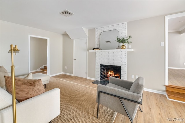 living room featuring a fireplace and light hardwood / wood-style floors