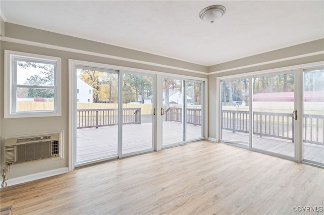 unfurnished sunroom featuring a wall mounted AC