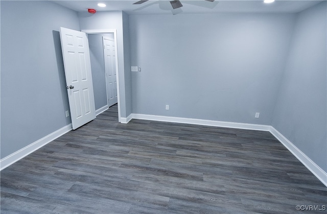 empty room with dark hardwood / wood-style floors and ceiling fan