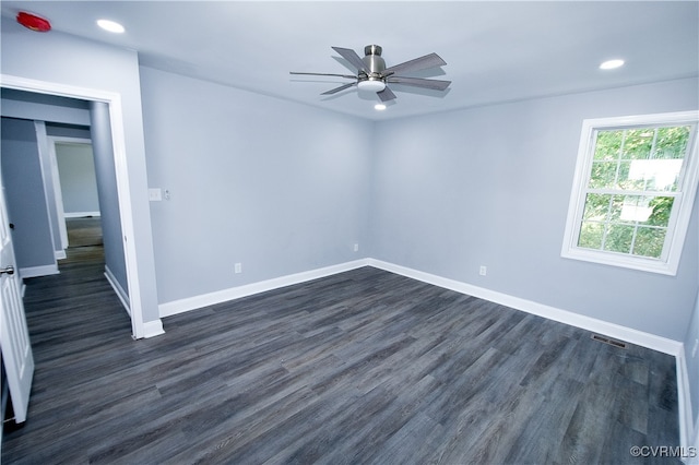 unfurnished room with dark hardwood / wood-style flooring and ceiling fan