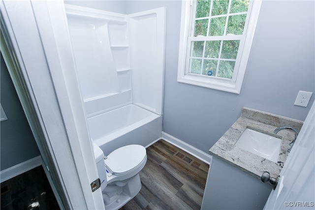 full bathroom featuring hardwood / wood-style floors, vanity, toilet, and shower / bath combination