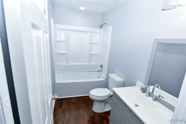 full bathroom featuring shower / bathing tub combination, hardwood / wood-style floors, vanity, and toilet