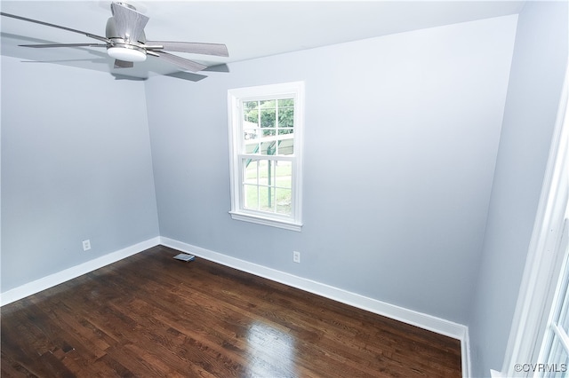 spare room featuring ceiling fan and dark wood-type flooring