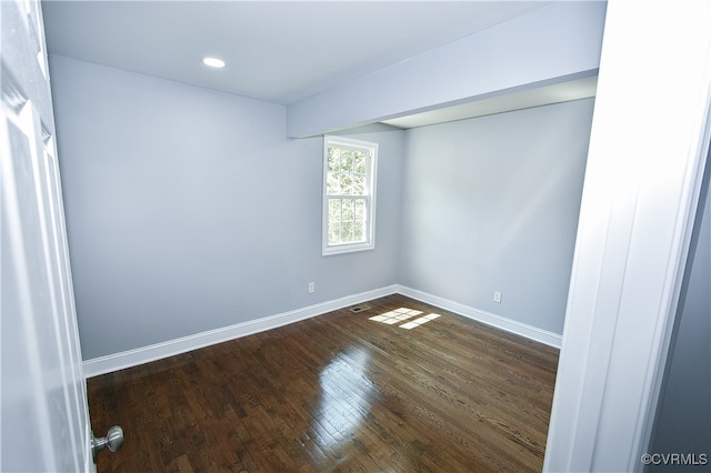 empty room with hardwood / wood-style flooring