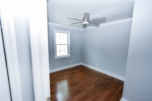 empty room featuring ceiling fan, dark hardwood / wood-style flooring, and crown molding