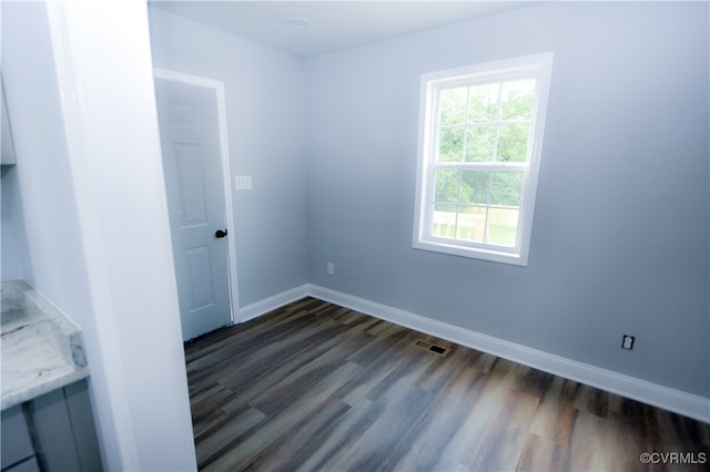 unfurnished room featuring dark hardwood / wood-style floors