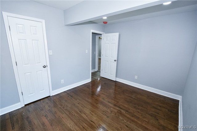 empty room featuring dark wood-type flooring