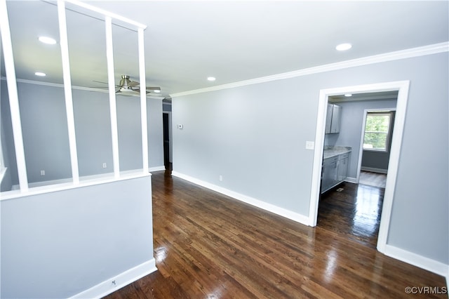 empty room with ceiling fan, dark hardwood / wood-style floors, and ornamental molding