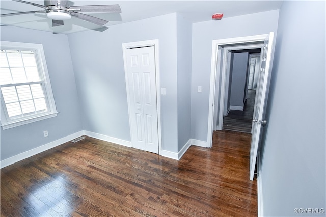 empty room featuring dark hardwood / wood-style flooring and ceiling fan