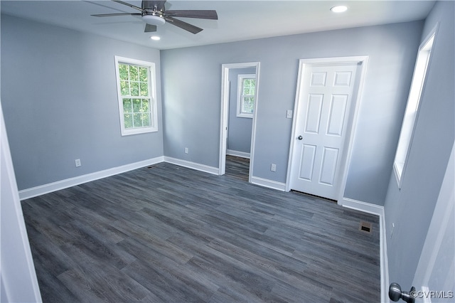 unfurnished bedroom featuring ceiling fan and dark hardwood / wood-style floors