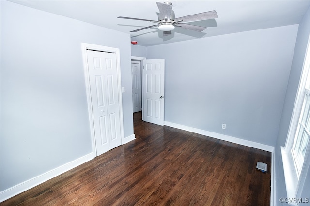 unfurnished bedroom with ceiling fan and dark hardwood / wood-style flooring