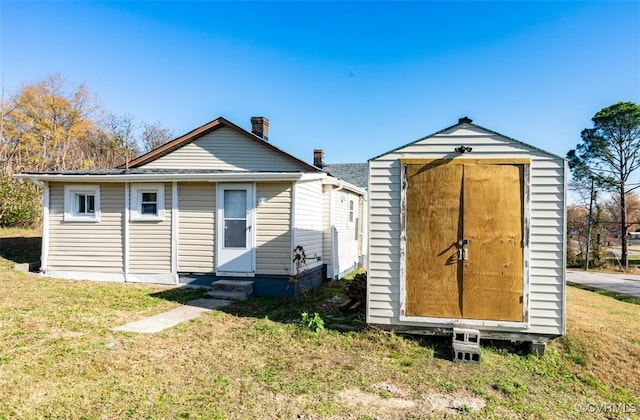 view of outbuilding featuring a yard