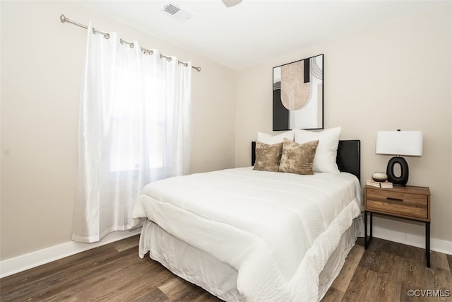 bedroom featuring dark hardwood / wood-style flooring