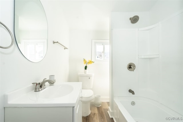 full bathroom featuring toilet, bathing tub / shower combination, hardwood / wood-style flooring, and vanity