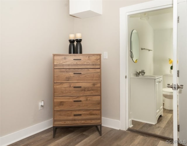 bathroom featuring toilet, vanity, and wood-type flooring