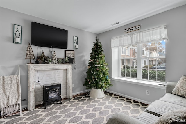 living room with a wood stove and carpet