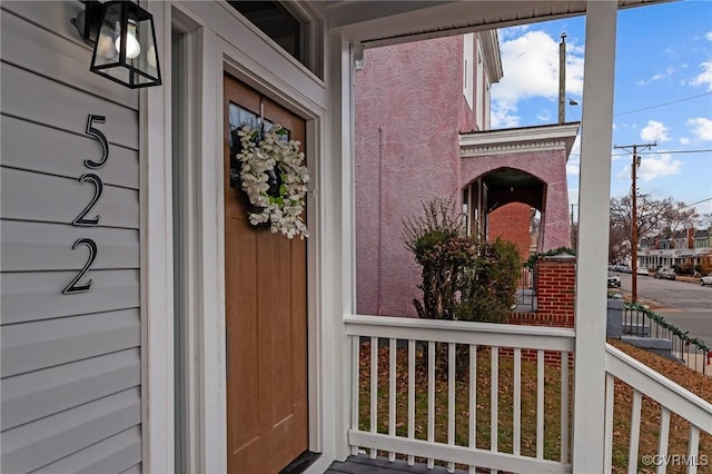 view of exterior entry featuring a porch