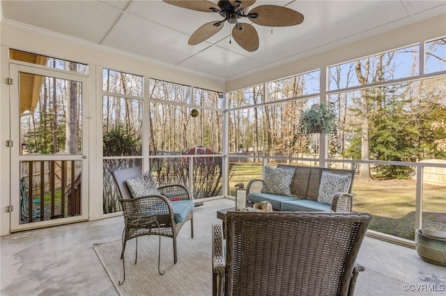 sunroom / solarium featuring ceiling fan and a healthy amount of sunlight