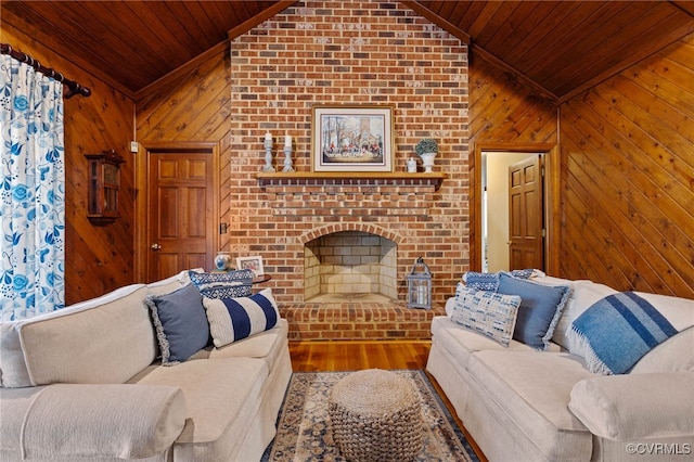 living room featuring wood walls, high vaulted ceiling, hardwood / wood-style flooring, a fireplace, and wood ceiling