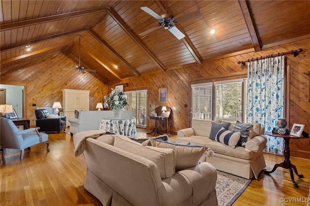 living room with vaulted ceiling with beams, light wood-type flooring, wooden ceiling, and wooden walls